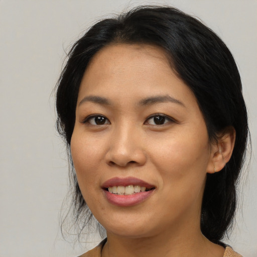 Joyful asian young-adult female with medium  brown hair and brown eyes