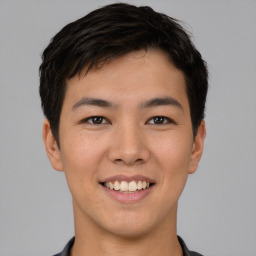 Joyful asian young-adult male with short  black hair and brown eyes