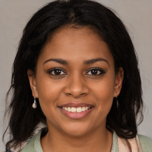 Joyful black young-adult female with medium  brown hair and brown eyes