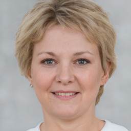 Joyful white adult female with short  brown hair and grey eyes