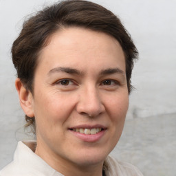 Joyful white adult female with short  brown hair and brown eyes