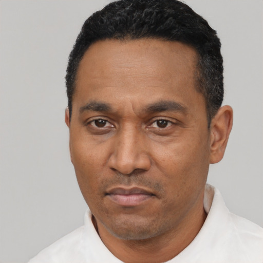 Neutral latino adult male with short  black hair and brown eyes