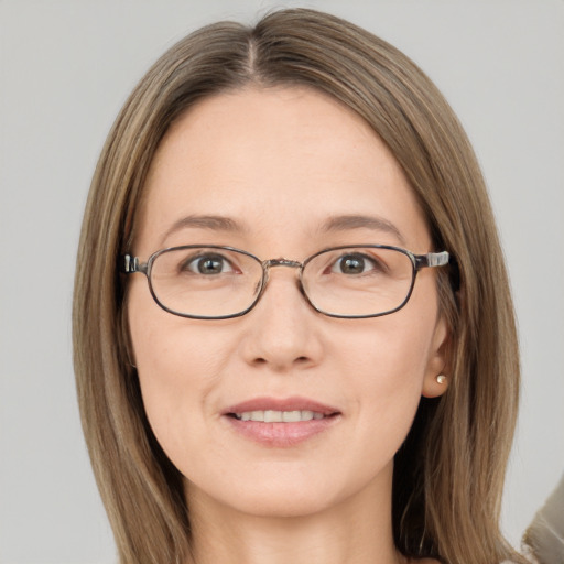 Joyful white adult female with long  brown hair and brown eyes