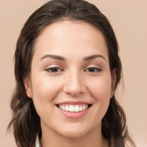 Joyful white young-adult female with long  brown hair and brown eyes