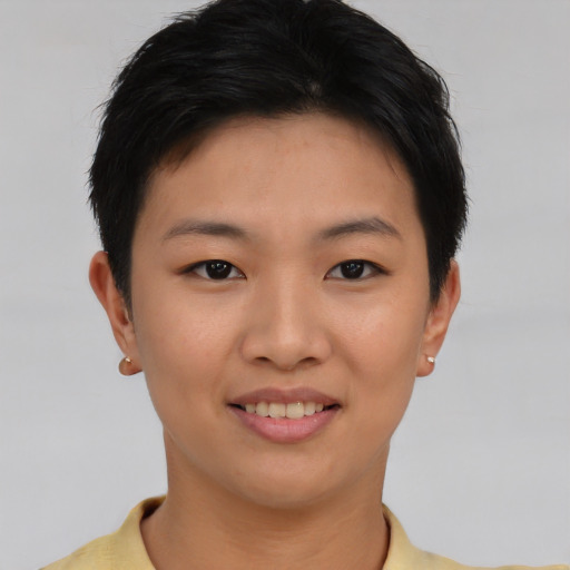Joyful asian young-adult female with short  black hair and brown eyes