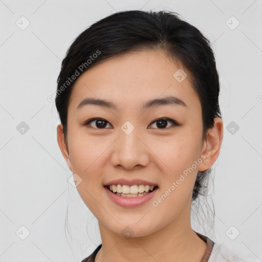 Joyful asian young-adult female with medium  black hair and brown eyes