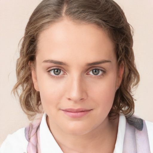 Joyful white young-adult female with medium  brown hair and blue eyes