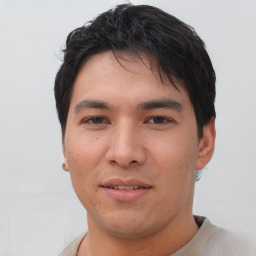 Joyful asian young-adult male with short  black hair and brown eyes