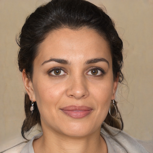 Joyful white adult female with medium  brown hair and brown eyes