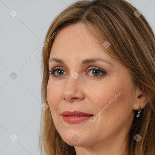 Joyful white adult female with long  brown hair and brown eyes