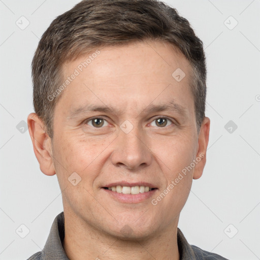 Joyful white adult male with short  brown hair and brown eyes