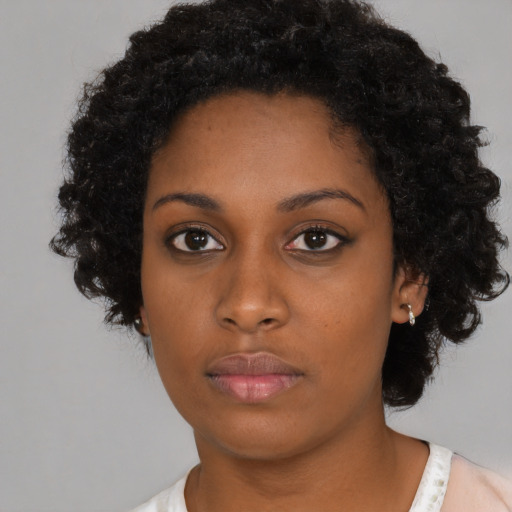 Neutral black young-adult female with medium  black hair and brown eyes
