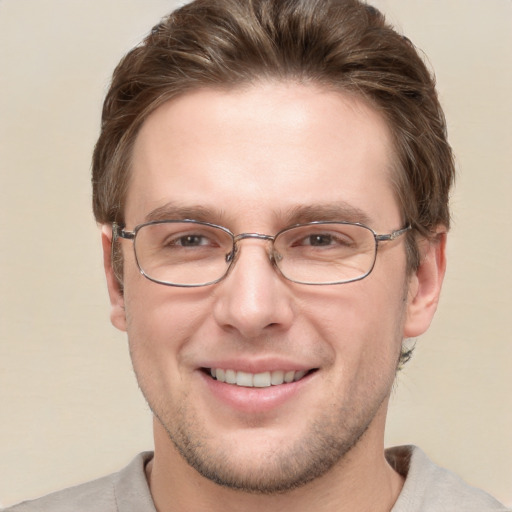 Joyful white adult male with short  brown hair and grey eyes