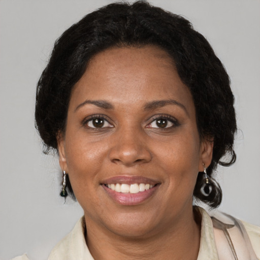 Joyful black adult female with short  brown hair and brown eyes