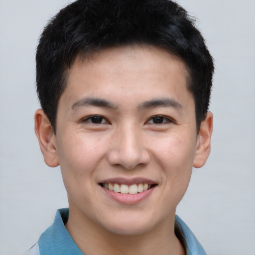 Joyful asian young-adult male with short  brown hair and brown eyes