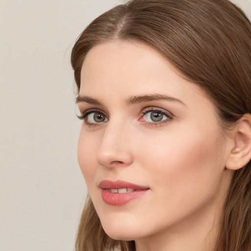 Joyful white young-adult female with long  brown hair and grey eyes