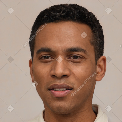 Joyful black young-adult male with short  black hair and brown eyes