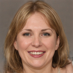 Joyful white adult female with medium  brown hair and grey eyes