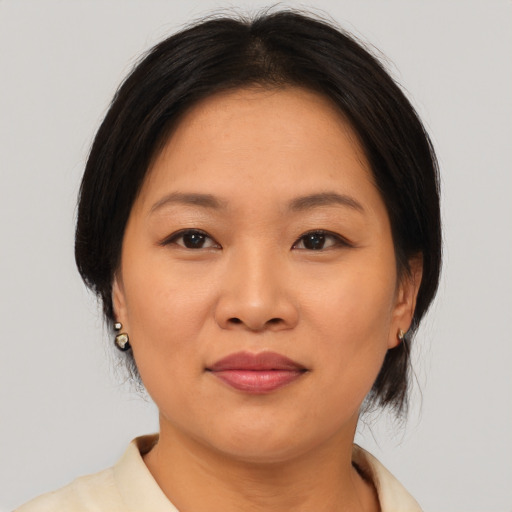 Joyful asian young-adult female with medium  brown hair and brown eyes