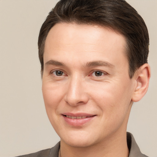 Joyful white young-adult male with short  brown hair and brown eyes