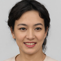 Joyful asian young-adult female with medium  brown hair and brown eyes