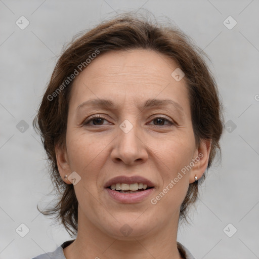 Joyful white adult female with medium  brown hair and brown eyes