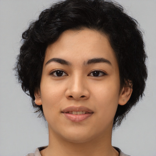 Joyful latino young-adult female with medium  black hair and brown eyes