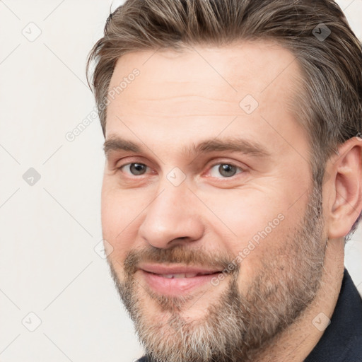 Joyful white adult male with short  brown hair and brown eyes