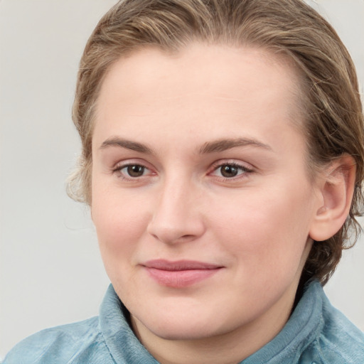 Joyful white young-adult female with medium  brown hair and blue eyes