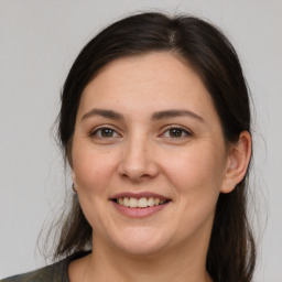 Joyful white young-adult female with medium  brown hair and brown eyes