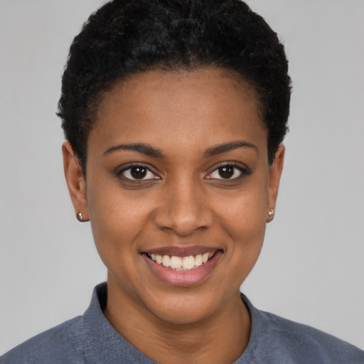 Joyful black young-adult female with short  brown hair and brown eyes