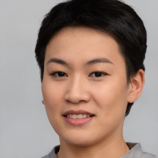 Joyful asian young-adult female with short  black hair and brown eyes