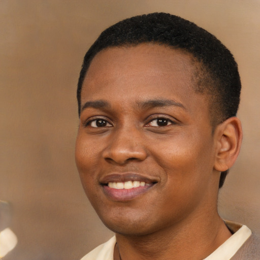 Joyful black young-adult female with short  brown hair and brown eyes