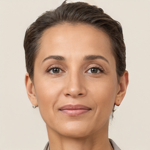 Joyful white adult female with short  brown hair and brown eyes