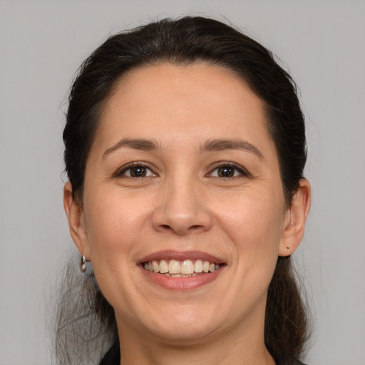 Joyful white adult female with medium  brown hair and brown eyes