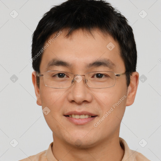 Joyful asian young-adult male with short  brown hair and brown eyes