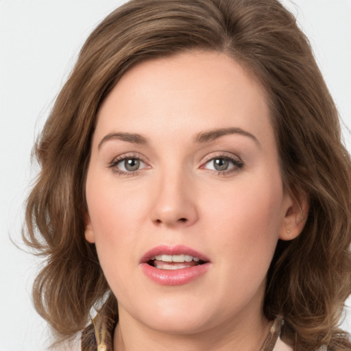 Joyful white young-adult female with medium  brown hair and green eyes