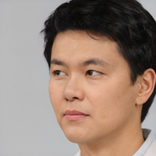 Neutral asian young-adult male with short  black hair and brown eyes