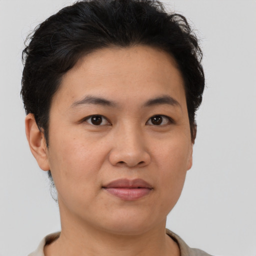 Joyful asian young-adult female with short  brown hair and brown eyes