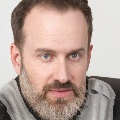 Joyful white adult male with short  brown hair and grey eyes