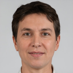 Joyful white adult male with short  brown hair and brown eyes