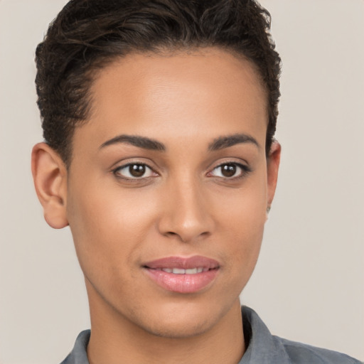 Joyful latino young-adult female with short  brown hair and brown eyes