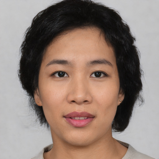 Joyful asian young-adult female with short  black hair and brown eyes