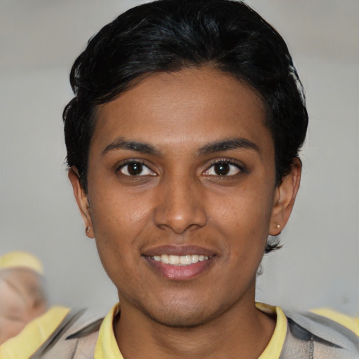 Joyful latino young-adult female with short  black hair and brown eyes