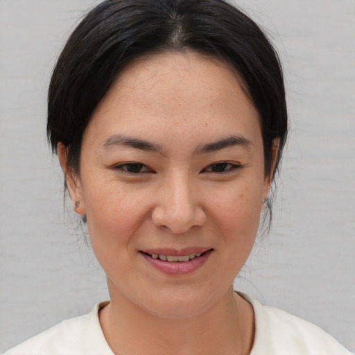 Joyful asian young-adult female with medium  brown hair and brown eyes