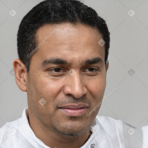 Joyful latino adult male with short  black hair and brown eyes