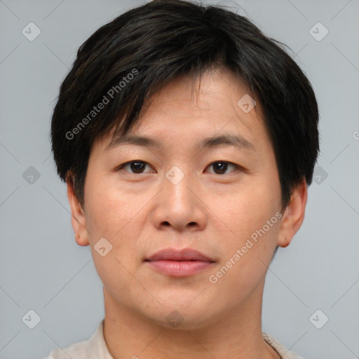 Joyful asian young-adult male with short  brown hair and brown eyes