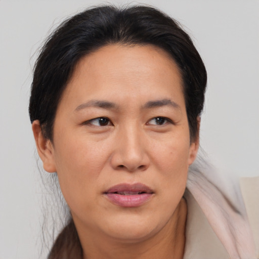 Joyful asian adult female with medium  brown hair and brown eyes