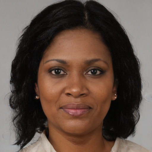 Joyful black adult female with medium  black hair and brown eyes