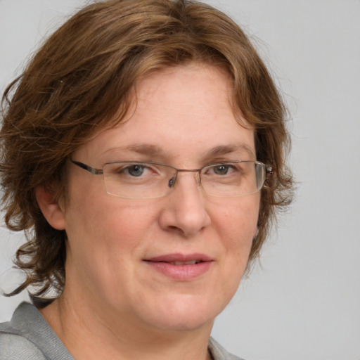 Joyful white adult female with medium  brown hair and blue eyes